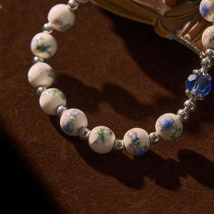 Bracciale Elasticizzato in Ceramica Floreale Multicolore con Medaglia Miracolosa e Crocifisso: Sottile Eleganza della Fede