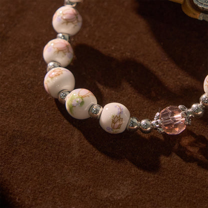 Bracciale Elasticizzato in Ceramica Floreale Multicolore con Medaglia Miracolosa e Crocifisso: Sottile Eleganza della Fede