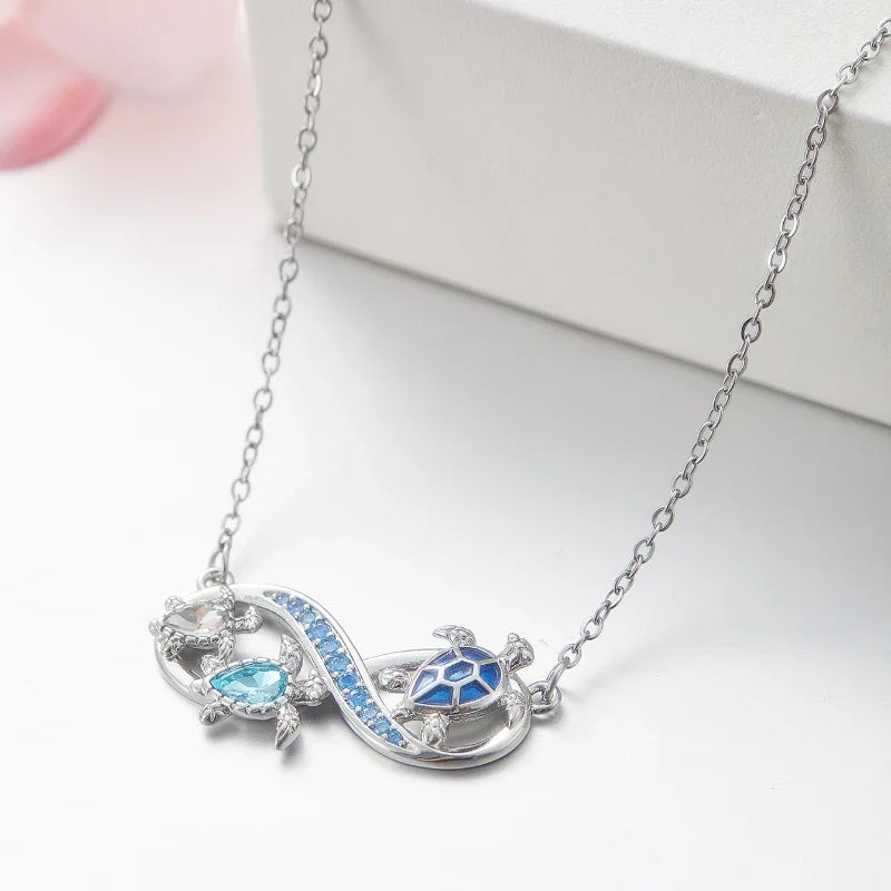 Collana Infinito con Tartarughe Marine e Cristalli Blu