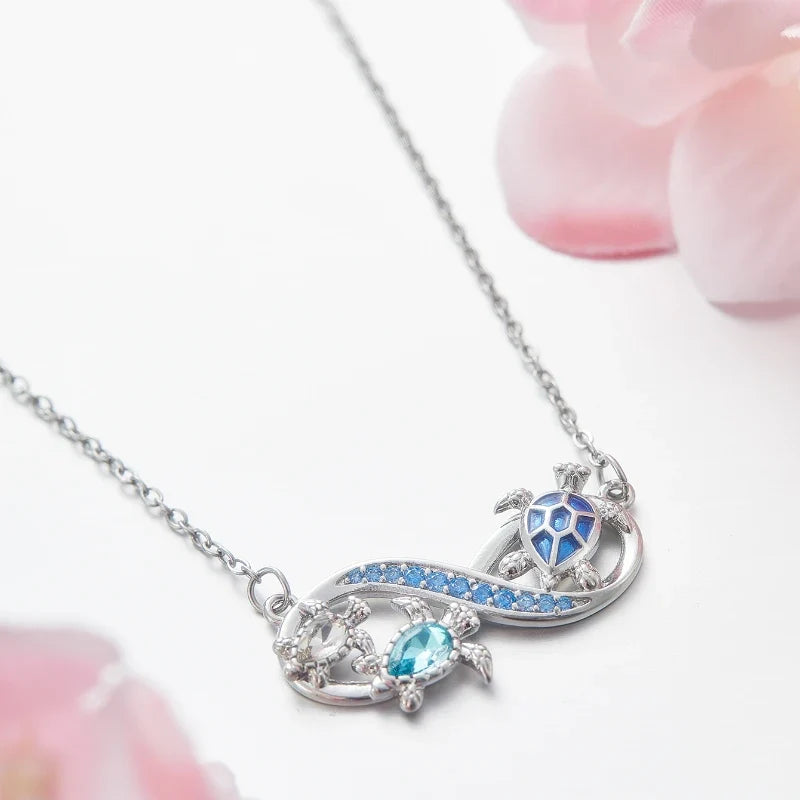Collana Infinito con Tartarughe Marine e Cristalli Blu